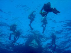 Divers starting a dive on south coast of Menorca. by Steven Withofs 